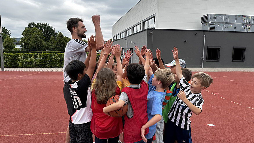 A group of children playing sports, with their coach.