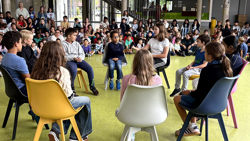 Students from Primary School talking in circles