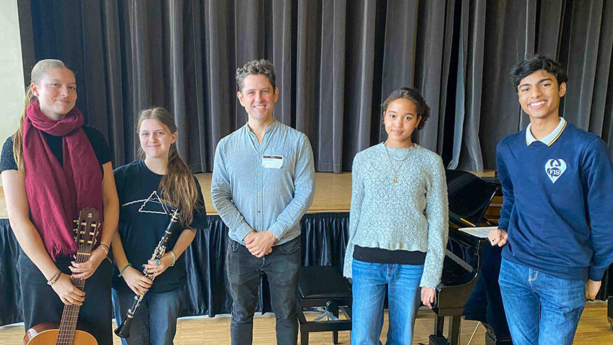 Composer Gordon Hamilton with a group of FIS students