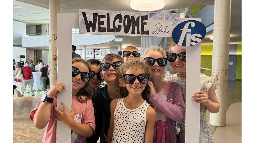 A group of students looking through a frame on the first day of school